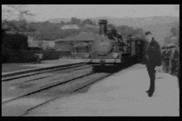a black and white photo of a train station