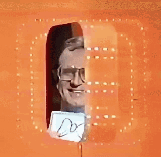 a man with glasses is smiling and holding a piece of paper that says dori .