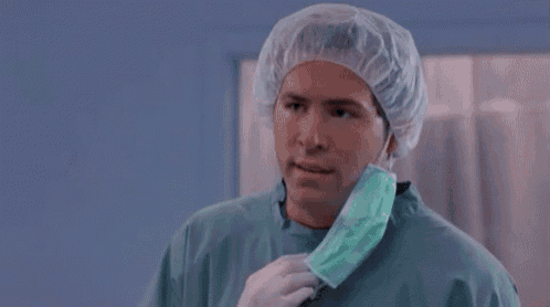 a surgeon wearing a surgical cap and mask is asking why .