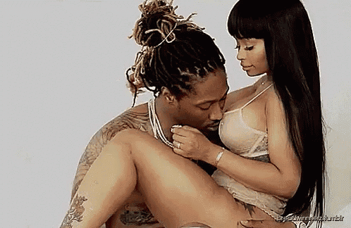 a man and a woman are sitting next to each other on a bed .