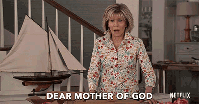 a woman says dear mother of god in front of a model boat