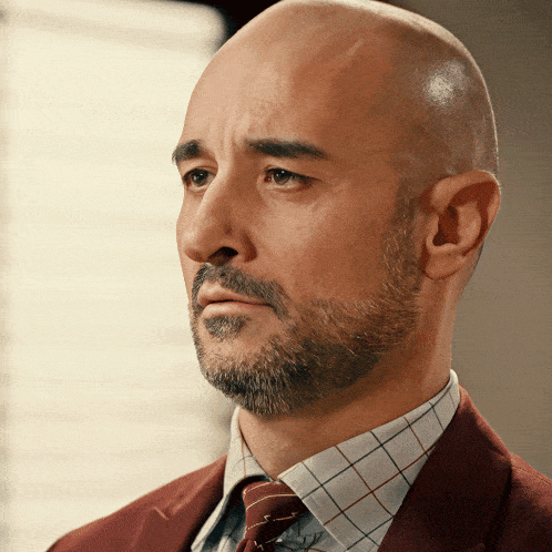 a man with a beard wearing a suit and tie