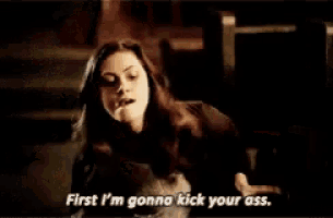 a woman is sitting in a chair and saying " first i 'm gonna kick your ass "