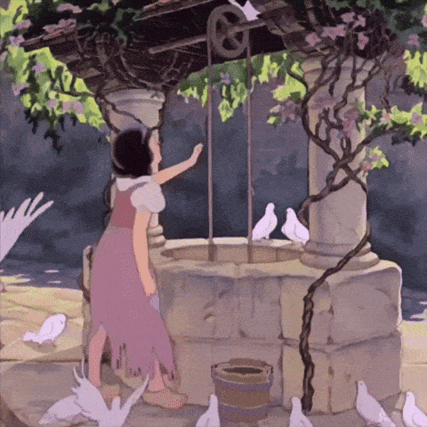 a girl in a purple dress reaches out to touch a well surrounded by pigeons