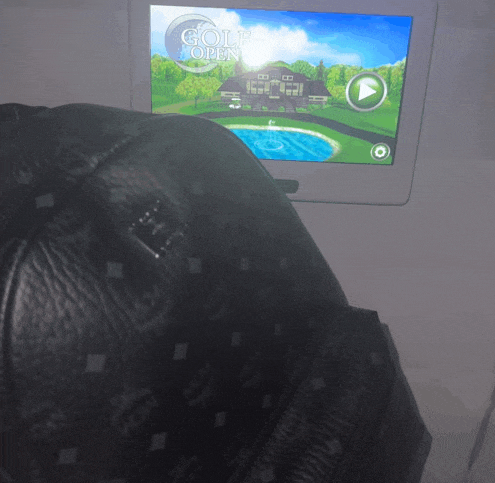 a mcm bag is sitting in front of a golf open screen
