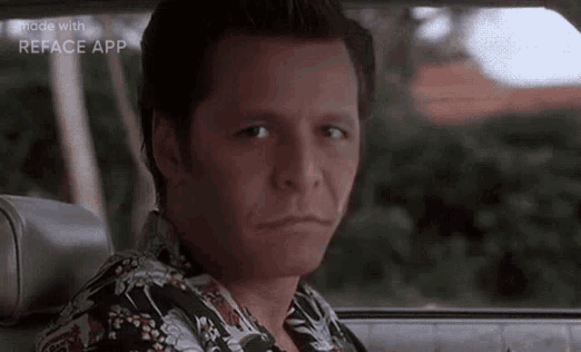 a man is sitting in the driver 's seat of a car and looking out the window .