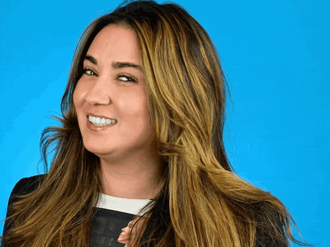 a woman with long brown hair is smiling and looking to the side