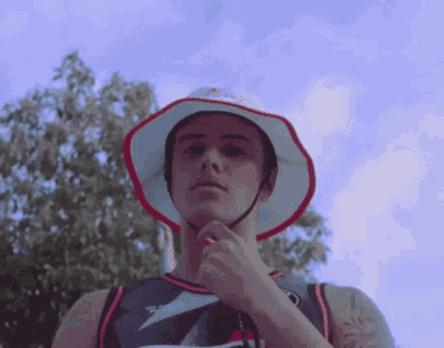 a man wearing a bucket hat and a jersey that says ' t.j. ' on it