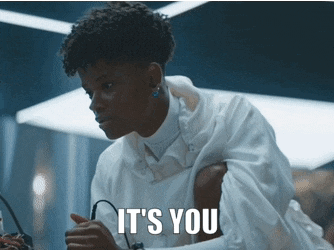 a woman in a white shirt says it 's you in a dark room