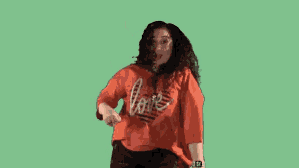 a woman wearing an orange shirt that says love on it