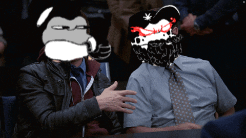 two men are sitting at a table and one has a cartoon face on his head