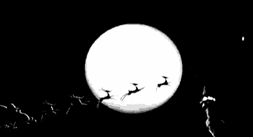 a black and white photo of santa claus and his reindeer flying in front of a full moon in a sleigh .