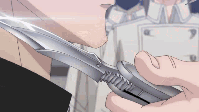 a person is holding a silver object in their hand