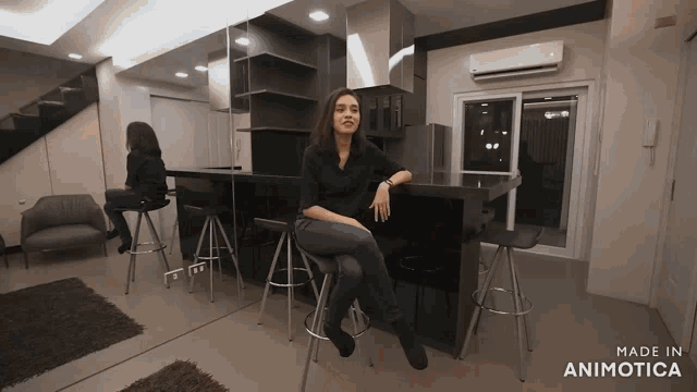 a woman sits on a bar stool in a room that is made in animotica