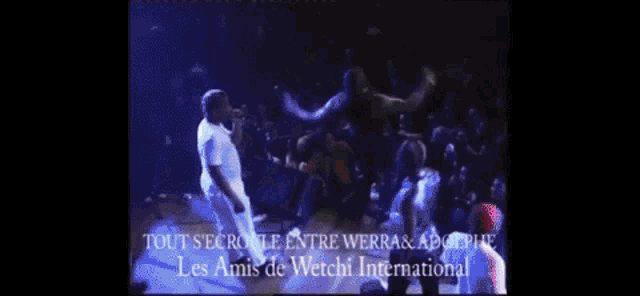 a group of people are dancing in front of a crowd and the words tout se roule entre herra & adolphe
