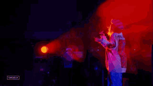 a person standing in front of a microphone with the word cancella on the bottom right