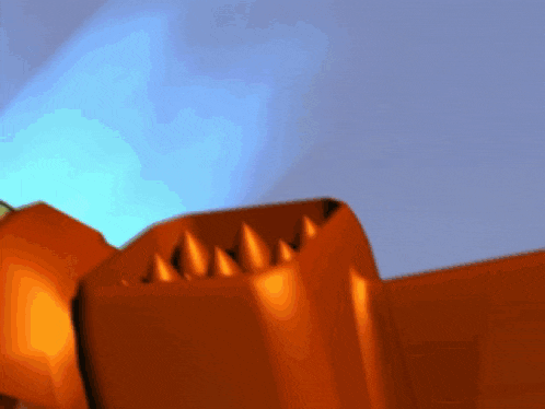 a close up of an orange object with a blue background