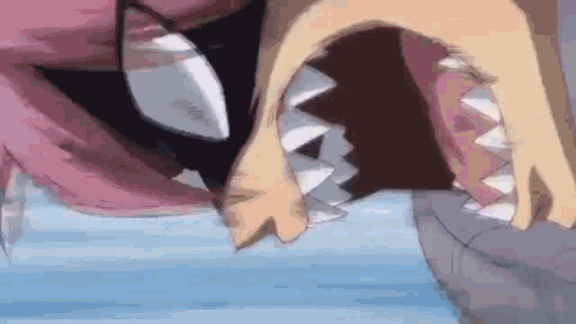 a close up of a person 's mouth with sharp teeth and a knife in it .