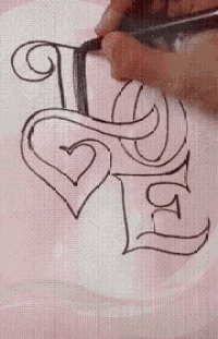 a person is drawing a letter l with a heart on it