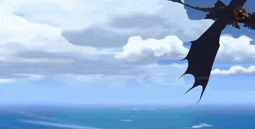 a dragon is flying over the ocean with a blue sky in the background
