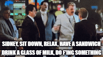 a group of men are standing in a room with a caption that says drink a glass of milk