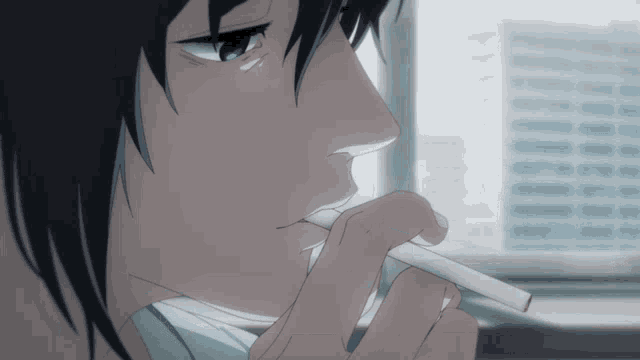 a close up of a person 's face with a cigarette in their mouth