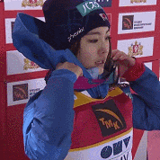 a woman wearing a tmk vest and a hat