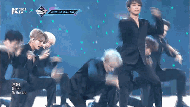 a group of men are performing on a stage with the words to the top on the bottom of the screen