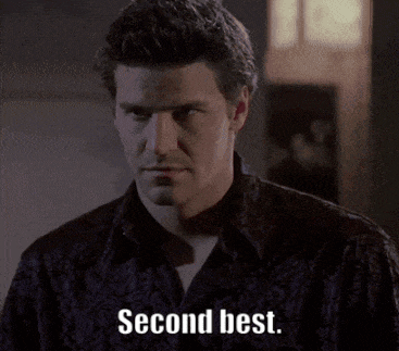a man in a black shirt says " second best " in white letters