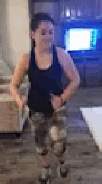 a woman is standing in a living room wearing roller skates .