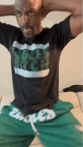 a man wearing a black shirt that says ugly bitch on it
