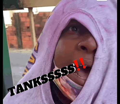 a person wearing a hooded sweatshirt with tanksssss written on the bottom