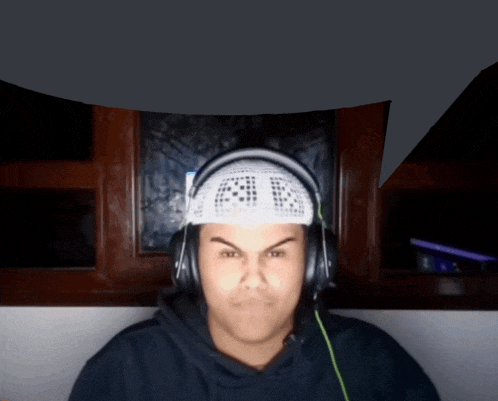 a man wearing headphones and a headband that says ' aa ' on it