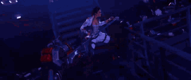 a robot is walking down a set of stairs in a dark room with red lights .