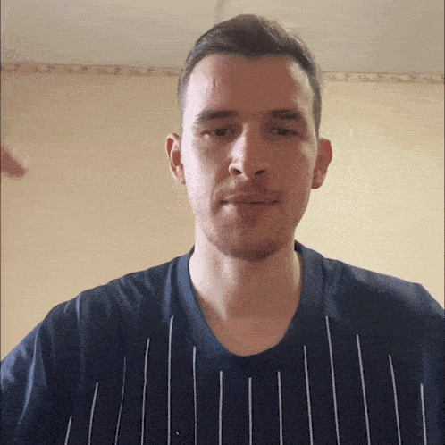 a man with a beard wearing a striped shirt