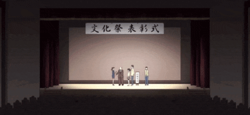 a group of people standing on a stage with chinese writing on the wall behind them