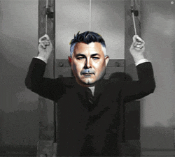 a man in a suit is hanging upside down with his hands up