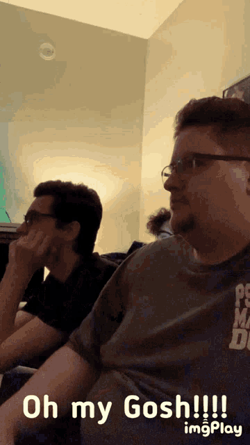 two men are sitting on a couch with the caption oh my gosh !!! imgplay