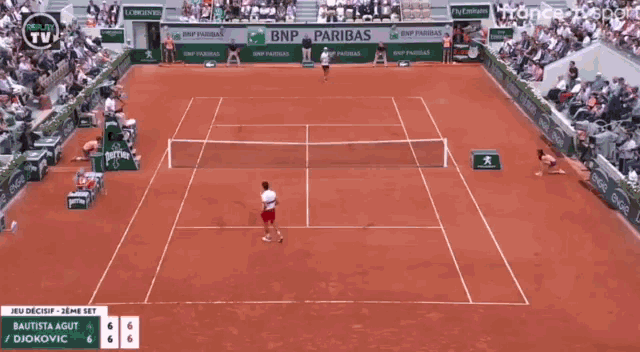 a tennis match is being played on a court with bnp and paribas advertisements