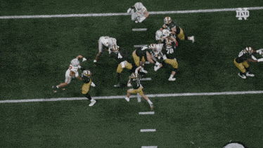 a football player in a white jersey is being tackled by a player in a black uniform