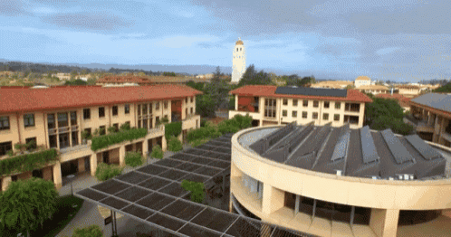 an aerial view of a university campus with a clock tower in the background