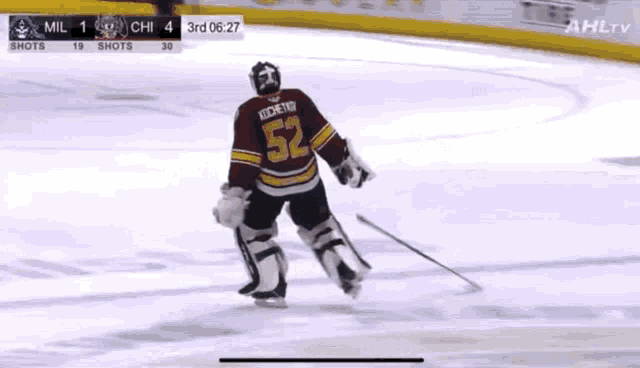 a hockey player with the number 52 on his jersey is skating on the ice