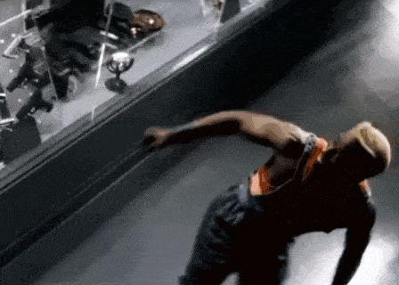 a man is doing a handstand in front of a mirror .