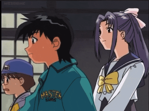 a boy in a master kings shirt stands next to a girl in a sailor uniform