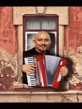a man is holding an accordion and looking out a window