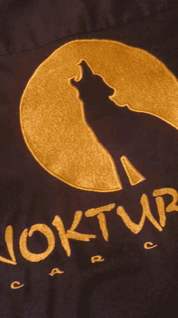 a purple shirt with the word turnal written in gold