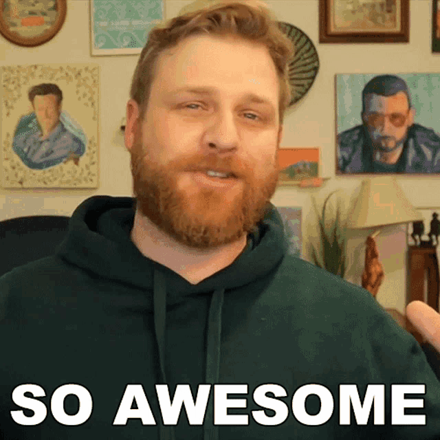 a man with a beard wears a green hoodie and says so awesome