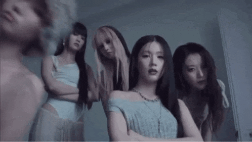 a group of young women are standing next to each other in a room .