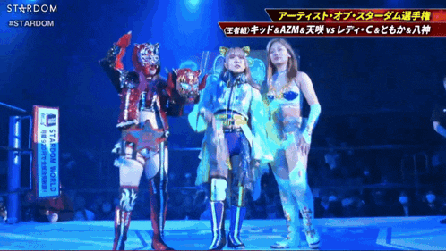 three women are standing on a stage with a sign that says stardom