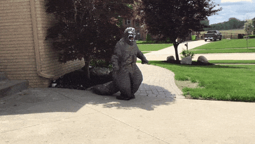 a statue of a gorilla standing on a sidewalk